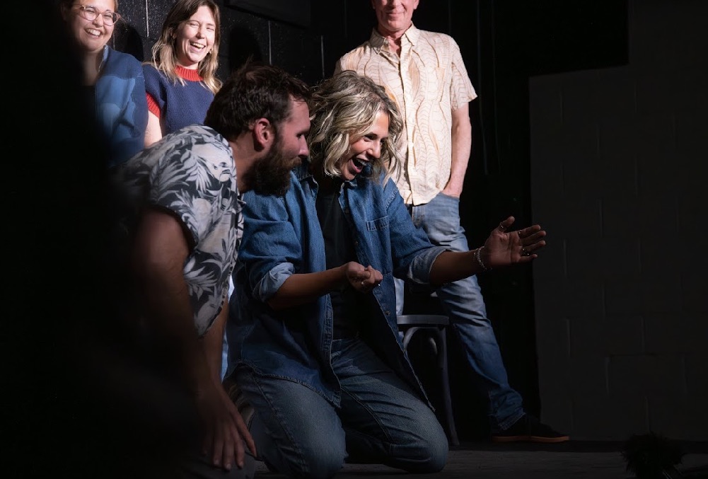 Performers laughing during an improv scene