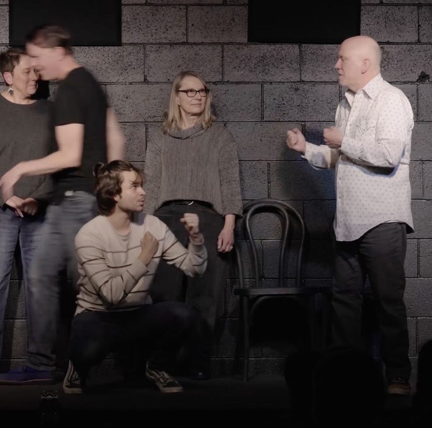Improvisers performing on the black box stage