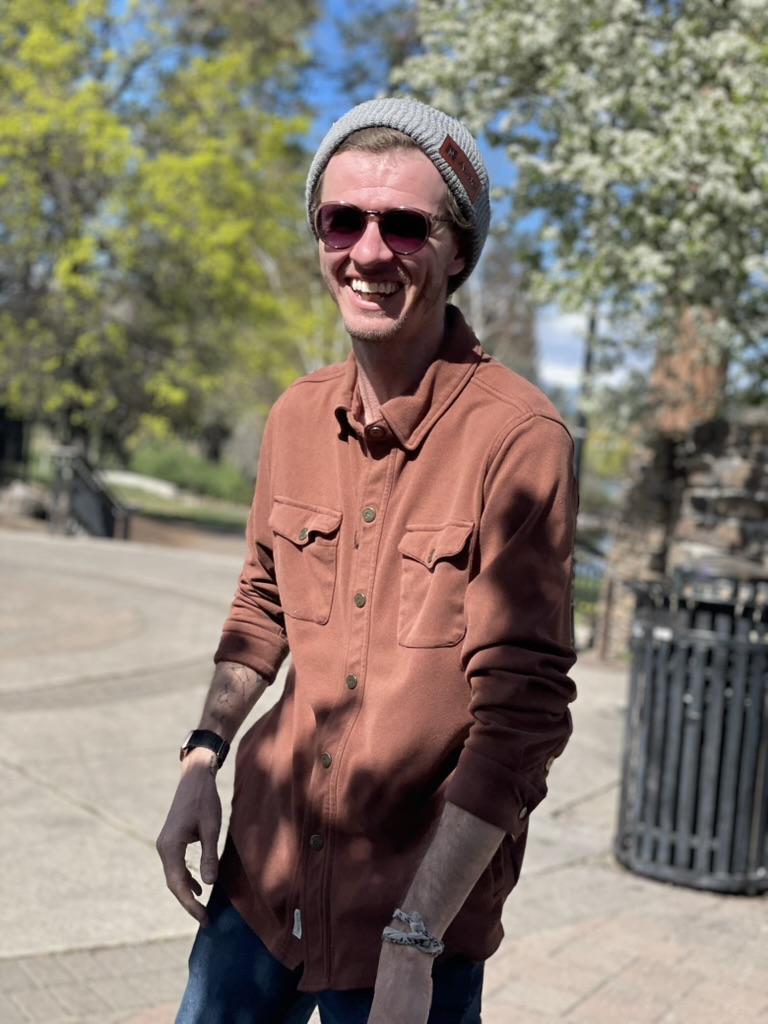 Performer smiling outdoors in spring
