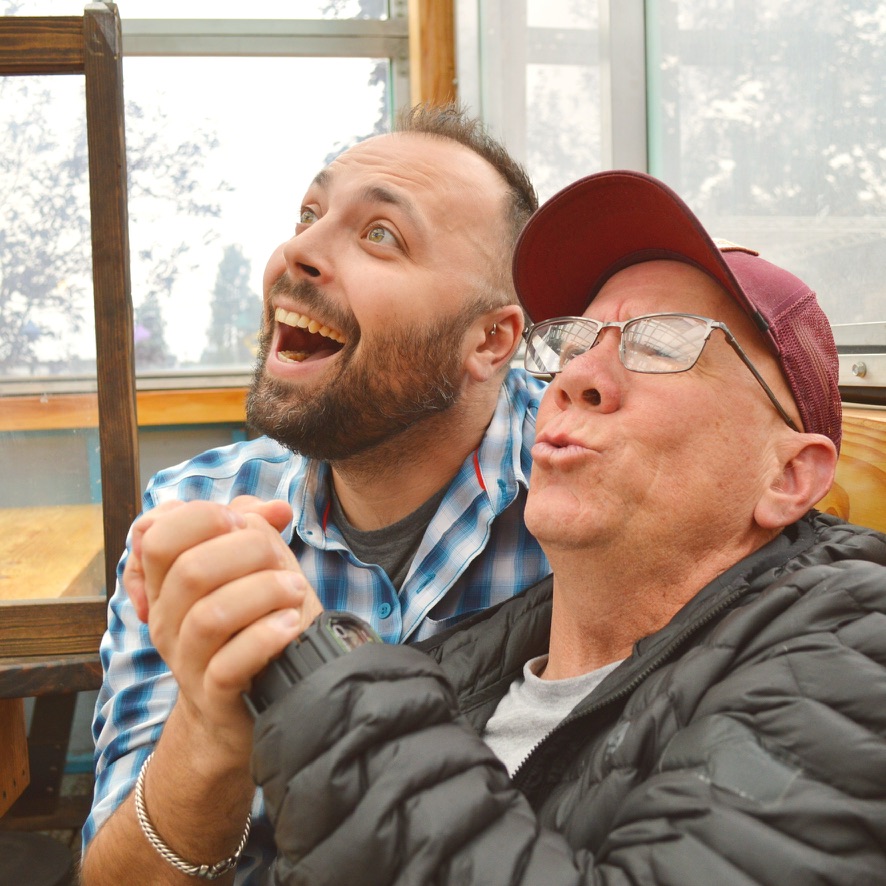 Two performers mid-scene, one cheering, one puckered