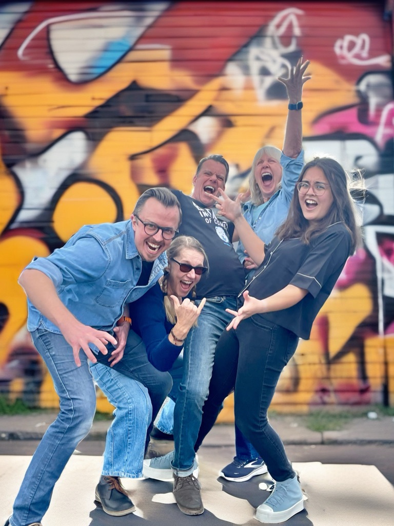 Performers in front of a graffiti wall
